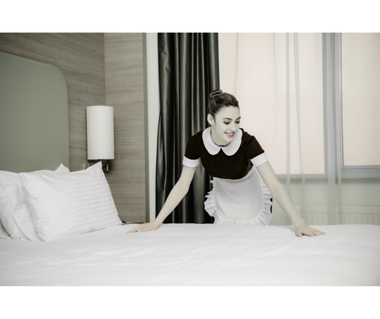 Maid in Uniform Making Bed Photo